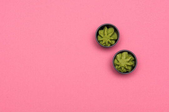 Wasabi paste flat lay on pick background, copy space. Concept for Japanese cuisine, cooking or food delivery