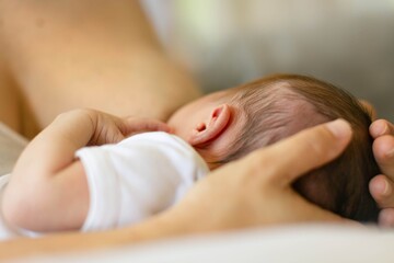 A mother nursing her baby. Breastfeeding.