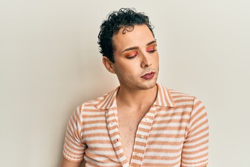 Fototapeta premium Handsome man wearing make up wearing casual shirt screaming proud, celebrating victory and success very excited with raised arms