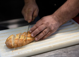 cook cutting bread 