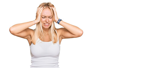 Obraz na płótnie Canvas Young blonde girl wearing casual style with sleeveless shirt suffering from headache desperate and stressed because pain and migraine. hands on head.