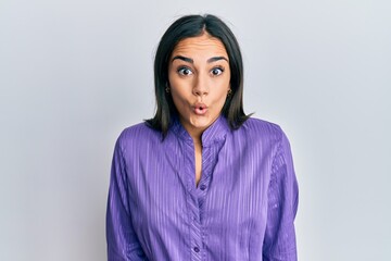 Fototapeta premium Young brunette woman wearing casual clothes afraid and shocked with surprise expression, fear and excited face.