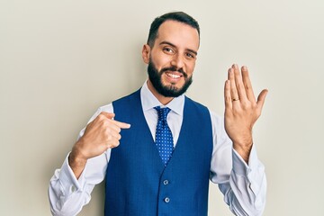 Young man with beard wearing engagement ring pointing finger to one self smiling happy and proud