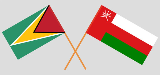 Crossed flags of Guyana and Oman. Official colors. Correct proportion