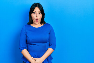 Young hispanic woman wearing casual clothes afraid and shocked with surprise expression, fear and excited face.