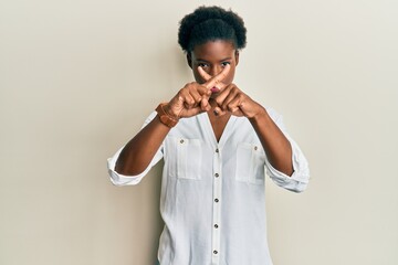 Young african american girl wearing casual clothes rejection expression crossing fingers doing negative sign