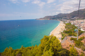 Obraz premium Beach in Alanya, Turkey. View and heights, top view. Blue sea in summer. Vacation in Turkey. Cleopatra beach.