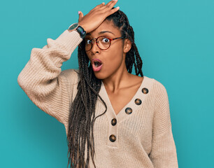 African american woman wearing casual clothes surprised with hand on head for mistake, remember...