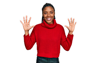 African american woman wearing casual winter sweater showing and pointing up with fingers number ten while smiling confident and happy.