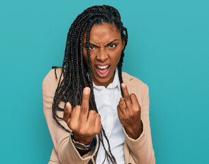 African american woman wearing business jacket showing middle finger doing fuck you bad expression,...