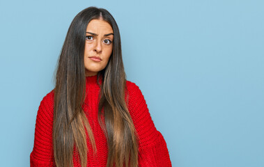 Beautiful hispanic woman wearing casual clothes skeptic and nervous, frowning upset because of...