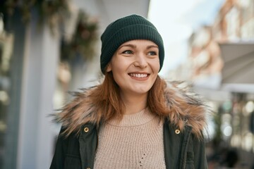 Young caucasian girl smiling happy standing at the city.