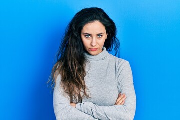 Obraz premium Young hispanic woman wearing casual clothes skeptic and nervous, disapproving expression on face with crossed arms. negative person.
