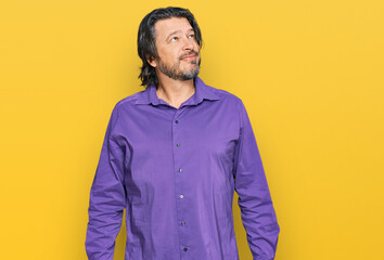 Middle age handsome man wearing business shirt looking away to side with smile on face, natural expression. laughing confident.