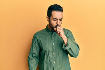 Young hispanic man wearing casual clothes feeling unwell and coughing as symptom for cold or bronchitis. health care concept.