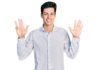 Naklejka premium Young hispanic business man wearing business clothes showing and pointing up with fingers number nine while smiling confident and happy.