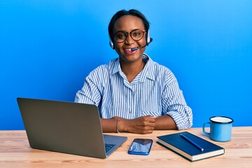 Young african woman wearing call center agent headset with a happy and cool smile on face. lucky person.