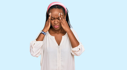 Young black woman wearing casual clothes with hand on head for pain in head because stress. suffering migraine.