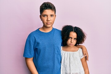 Obraz premium Young hispanic family of brother and sister wearing casual clothes together skeptic and nervous, frowning upset because of problem. negative person.
