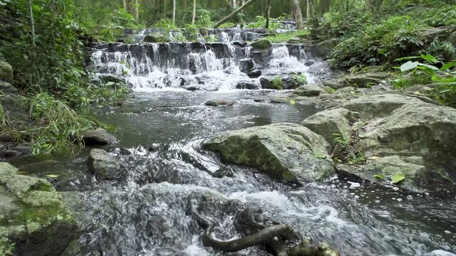 Beautiful stream and waterfall in tropical forest at Namtok Samlan National Park, Saraburi, Thailand - Slow Motion