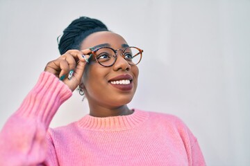 Young african american woman smiling happy at the city.