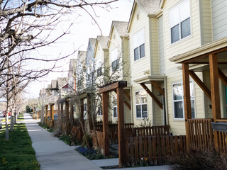 Regular street scene without people in a housing area with multiple units including condo or...