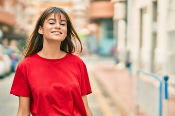 Caucasian teenager girl smiling happy standing at the city.