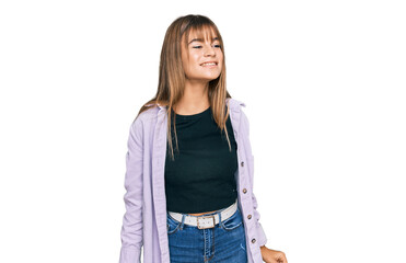 Teenager caucasian girl wearing casual clothes looking away to side with smile on face, natural expression. laughing confident.