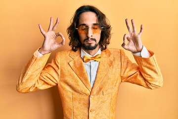 Young hispanic man wearing hipster elegant look relax and smiling with eyes closed doing meditation gesture with fingers. yoga concept.