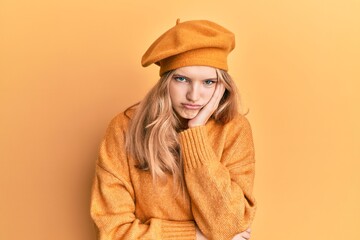 Beautiful young caucasian girl wearing french look with beret thinking looking tired and bored with depression problems with crossed arms.