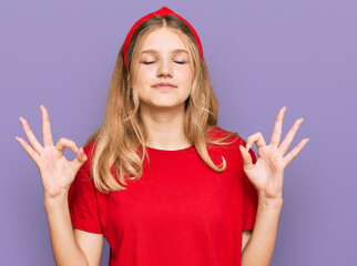 Beautiful young caucasian girl wearing casual red t shirt relax and smiling with eyes closed doing meditation gesture with fingers. yoga concept.