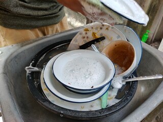 Wash the dishes in the sink