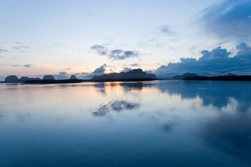 Aerial view beautiful sunrise or sunset sky in the morning sunrise drone is flying over sea with reflection light in water surface Landscape High angle view Dynamic aerial shot Amazing nature view