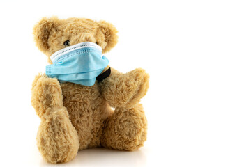 Teddy bears wearing protective mask, Teddy bear are sitting in blue medical masks on white background, Concept of protection from respiratory disease,Stop Coronavirus and Air pollution concept