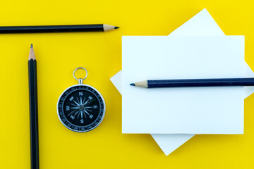 Top view business objects of white paper,pencil,and compass on paper work yellow background Flat lay composition