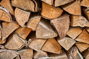Firewood from the end. The logs lie together in the firebox. Pieces of wood together. Nature symbol. Cutting down trees. High quality photo
