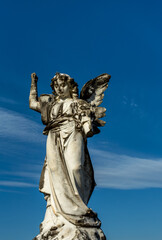 Angel statue against a blue sky (upward angle)