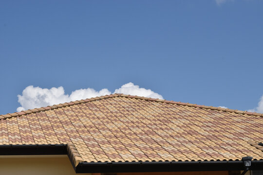 Image of Spanish tile roof and blue sky and clouds