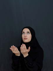 Portrait of young Muslim woman making dua