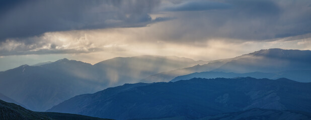 Fototapeta na wymiar Rainy weather in the mountains, evening light. Panoramic view.