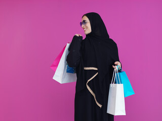 Happy Muslim woman posing with shopping bags