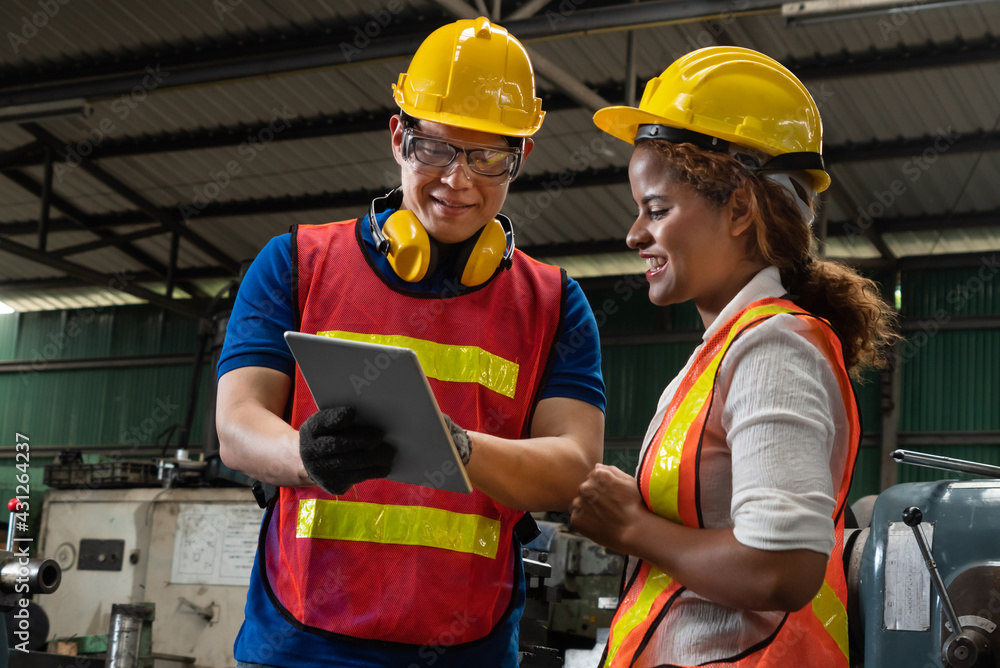 Poster two skillful factory engineer or worker discussing project on tablet computer . industrial people an
