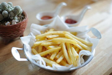 French fries in dish on the table, focusing
