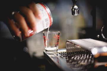 The barista is pouring the coffee mixture.