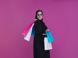 Happy Muslim woman posing with shopping bags