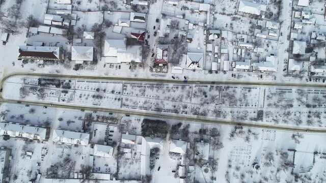 Fly over the village in snowy winter