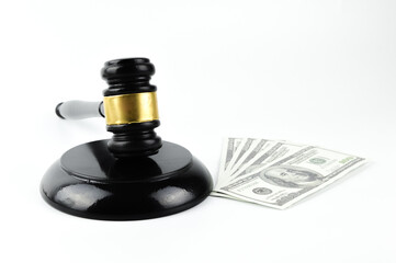 Judge gavel and money banknotes over white background