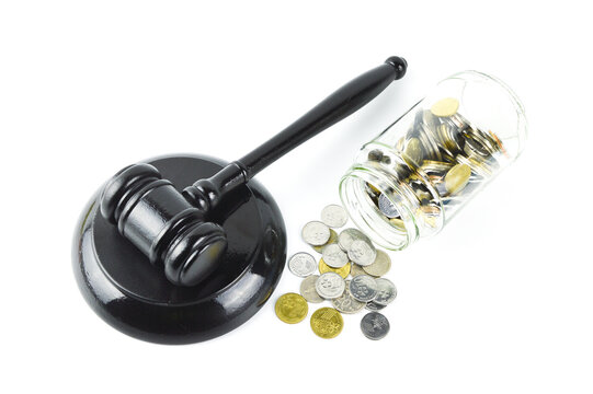 Stack of coins and judge gavel over white background