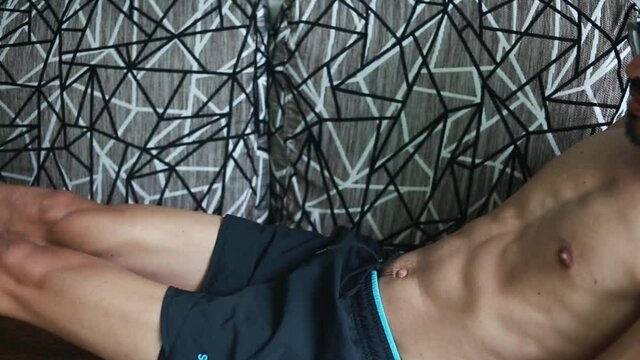 Lifestyle young man  do exercise with abs workout on sofa at home,  health while stay at home