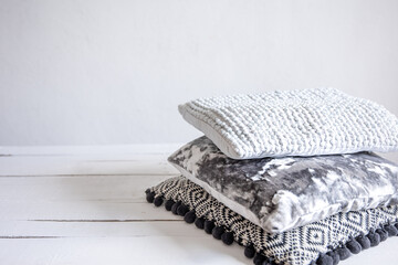 Close up of stylish pillows stacked in a stack.